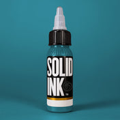 Solid Ink Agave tattoo ink 2 oz bottle on coloured background