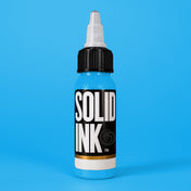 Solid Ink Baby Blue tattoo ink 2 oz bottle on coloured background