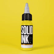 Solid Ink Banana tattoo ink 2 oz bottle on coloured background