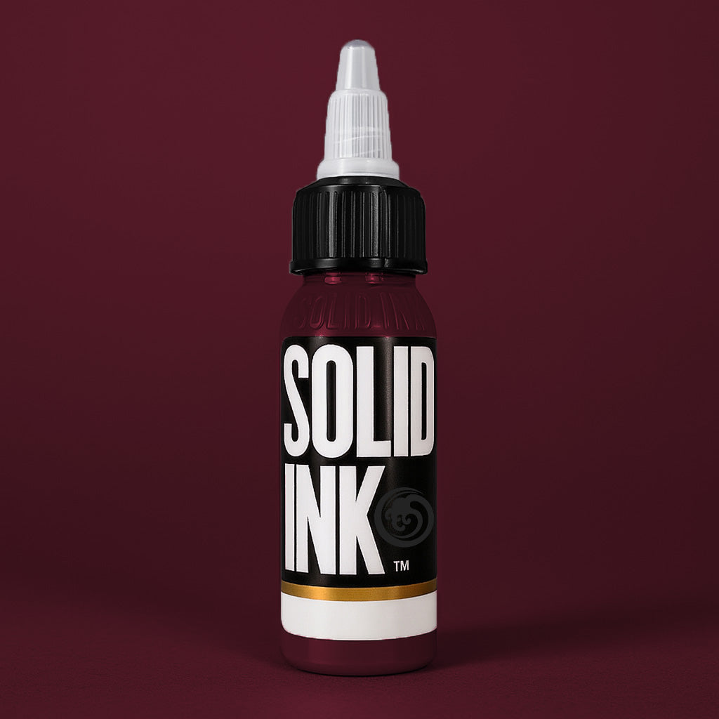 Solid Ink Bordeaux tattoo ink 2 oz bottle on coloured background