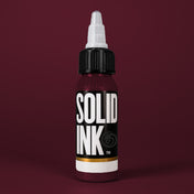 Solid Ink Bordeaux tattoo ink 2 oz bottle on coloured background