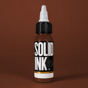 Solid Ink Brown tattoo ink 2 oz bottle on coloured background