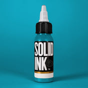 Solid Ink Cancun Blue tattoo ink 2 oz bottle on coloured background