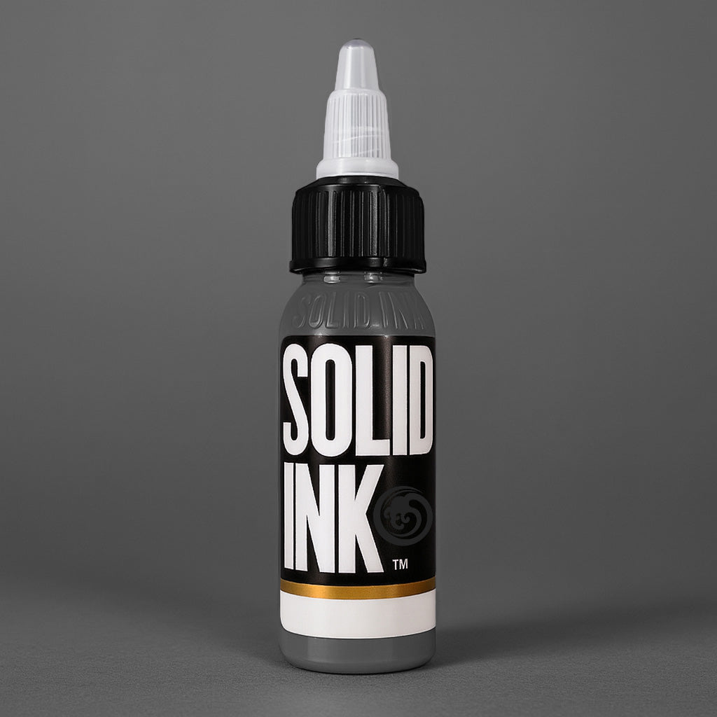 Solid Ink Cool Grey tattoo ink 2 oz bottle on coloured background