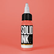 Solid Ink Coral tattoo ink 2 oz bottle on coloured background