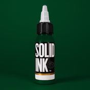 Solid Ink Dark Green tattoo ink 2 oz bottle on coloured background