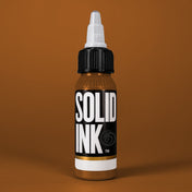 Solid Ink Dulce De Leche tattoo ink 2 oz bottle on coloured background