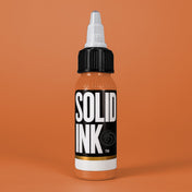 Solid Ink Flesh tattoo ink 2 oz bottle on coloured background