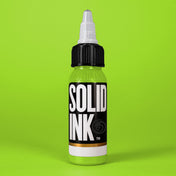 Solid Ink Lime Green tattoo ink 2 oz bottle on coloured background
