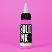 Solid Ink Lollipop tattoo ink 2 oz bottle on coloured background