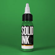 Solid Ink Medium Green tattoo ink 2 oz bottle on coloured background