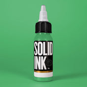 Solid Ink Mint tattoo ink 2 oz bottle on coloured background