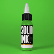Solid Ink Neon tattoo ink 2 oz bottle on coloured background