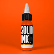 Solid Ink Orange tattoo ink 2 oz bottle on coloured background