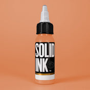 Solid Ink Peach Orange tattoo ink 2 oz bottle on coloured background