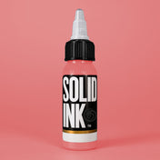 Solid Ink Pink tattoo ink 2 oz bottle on coloured background