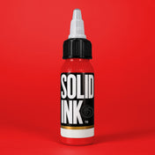 Solid Ink Power Red tattoo ink bottle on red background