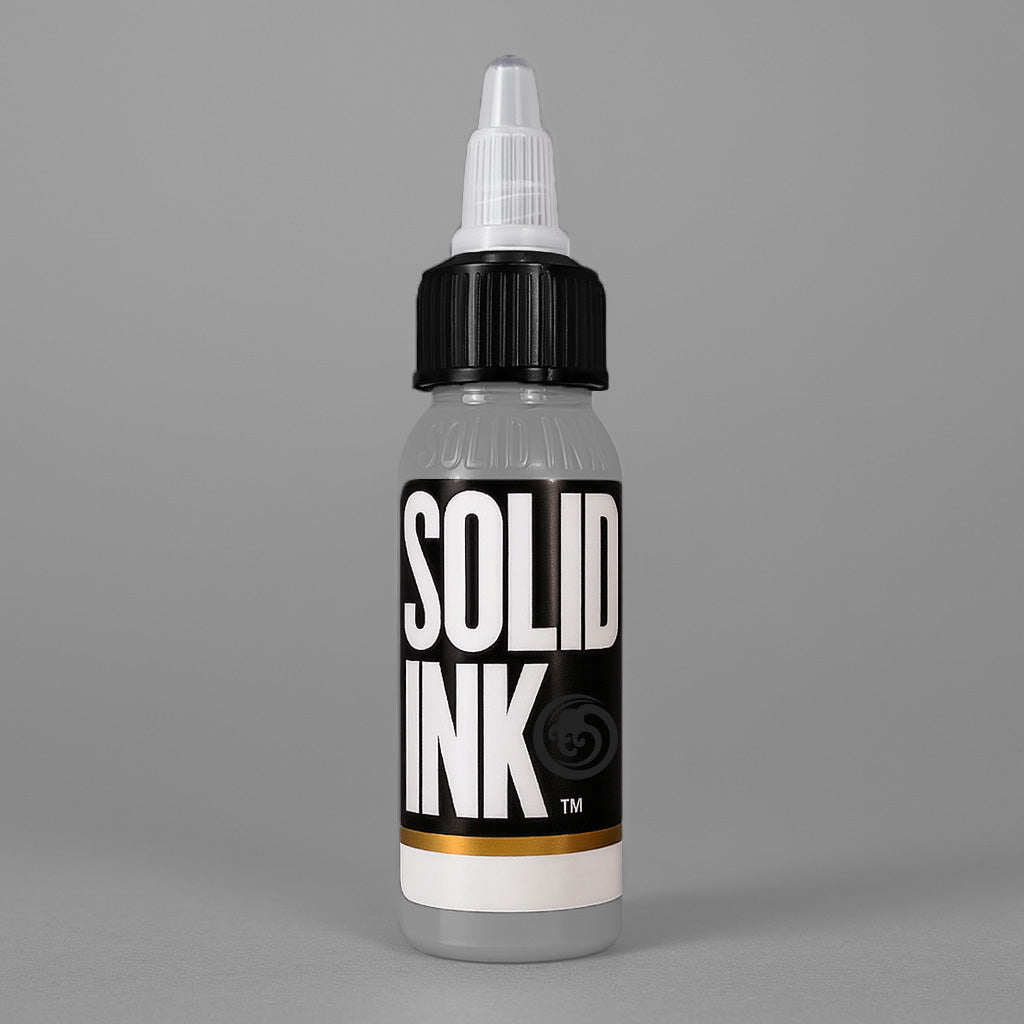 Solid Ink Silver tattoo ink 2 oz bottle on coloured background