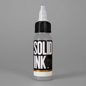 Solid Ink Silver tattoo ink 2 oz bottle on coloured background
