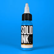 Solid Ink Sky Blue tattoo ink 2 oz bottle on coloured background