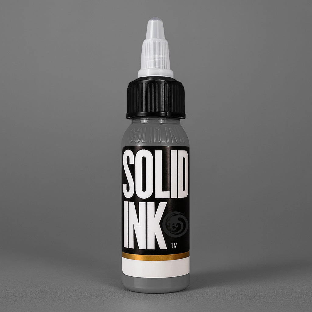 Solid Ink Smoke tattoo ink 2 oz bottle on coloured background