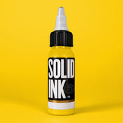 Solid Ink Sunshine tattoo ink 2 oz bottle on coloured background