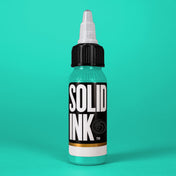 Solid Ink Teal tattoo ink 2 oz bottle on coloured background