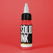 Solid Ink Watermelon tattoo ink 2 oz bottle on coloured background