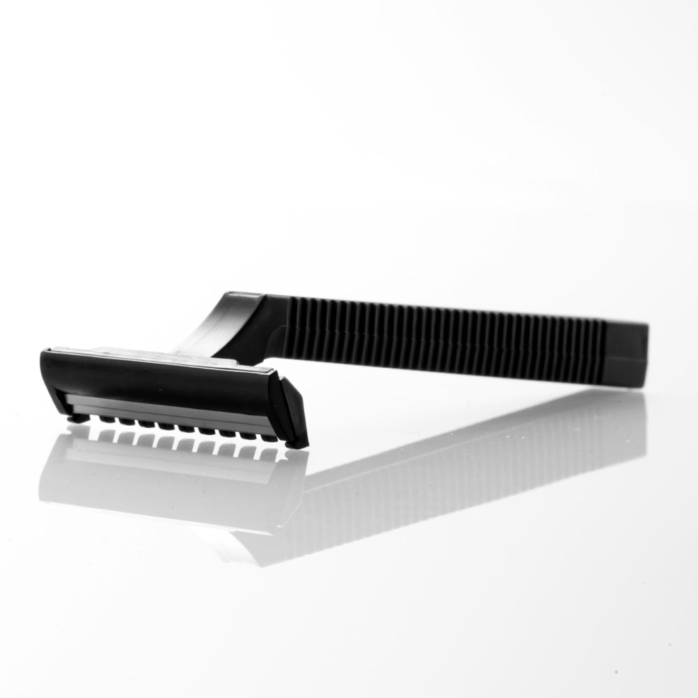 A single black Demons disposable razor laid flat on white
